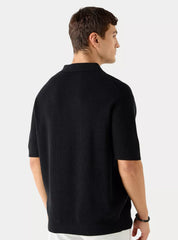 Vista traseira da camiseta polo masculina preta mostrando o caimento regular